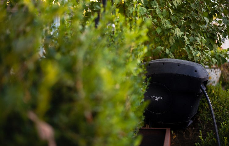 Picture of Hoselink Reel behind bushes