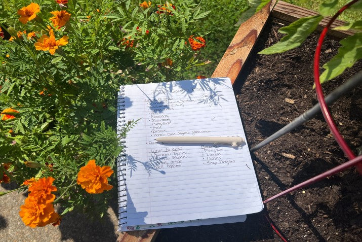 journal in garden with a pen