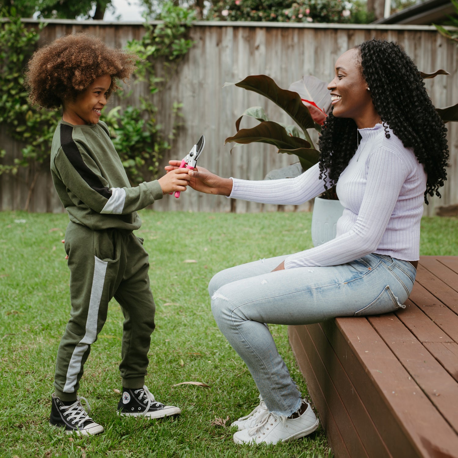 Young boy gifting his mum pink secateurs