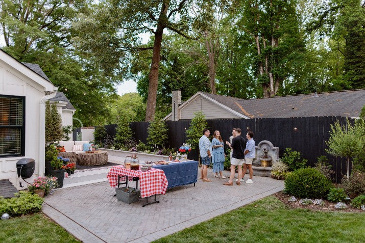 People gather in a backyard for a bbq party 