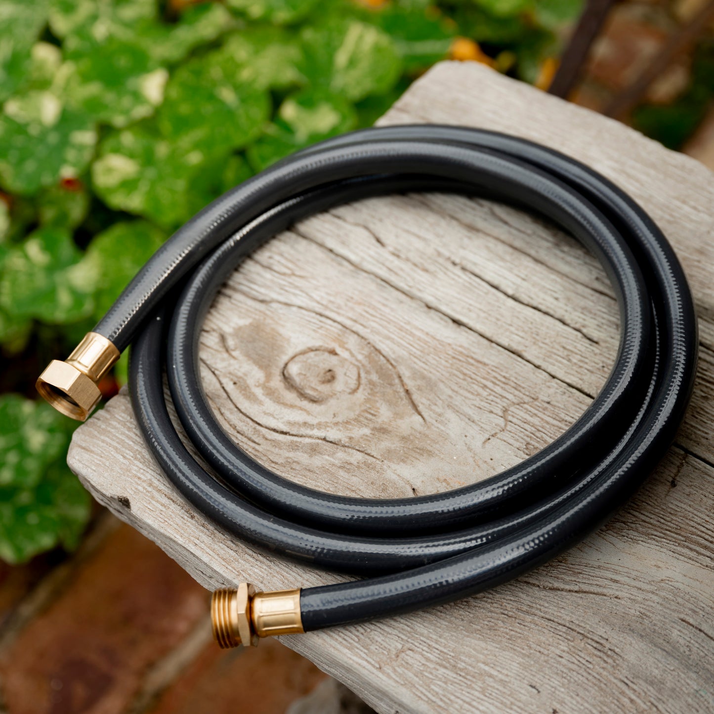 Coiled Charcoal-colour Hose Reel Leader Hose on bench