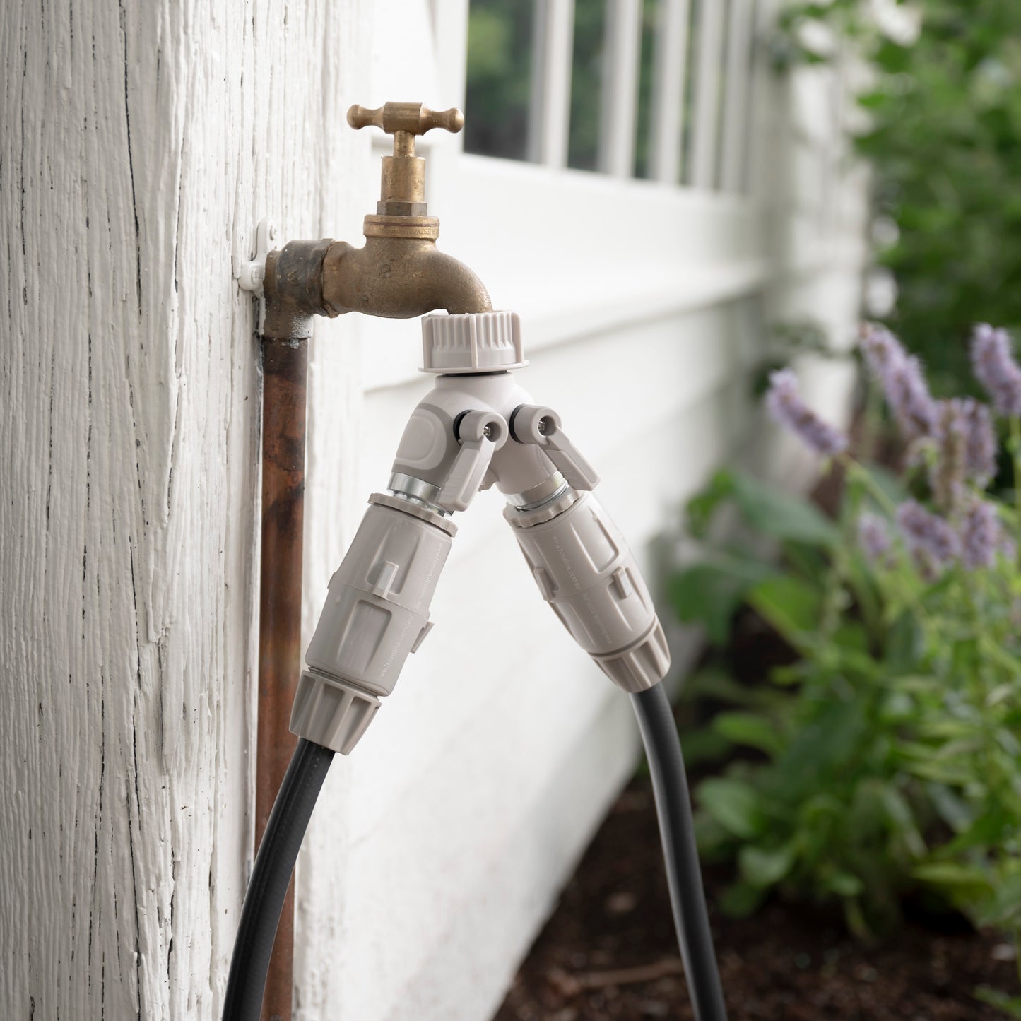 Easy Turn 2-Way Tap Adapter on faucet attached to hoses