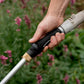 Close-up of the flow control lever on the Shower Spray Wand being pushed with male model's thumb