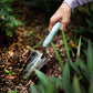 Hand using the Garden Trowel in a garden setting