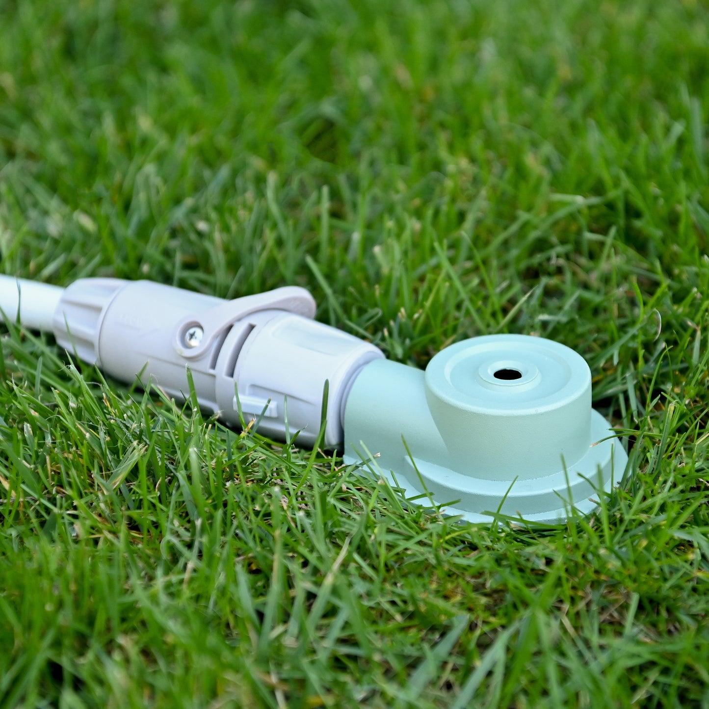round sprinkler on green grass