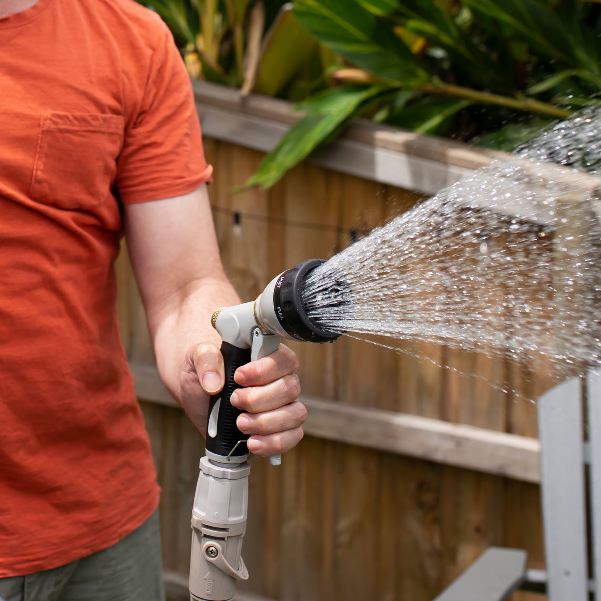 male watering garden using the 7 function spray gun
