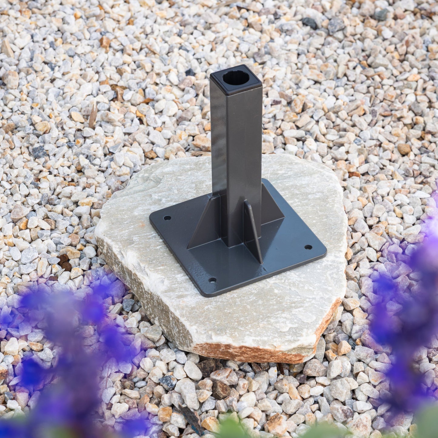 Ground Mount Classic series on a stone base with purple flowers in the foreground