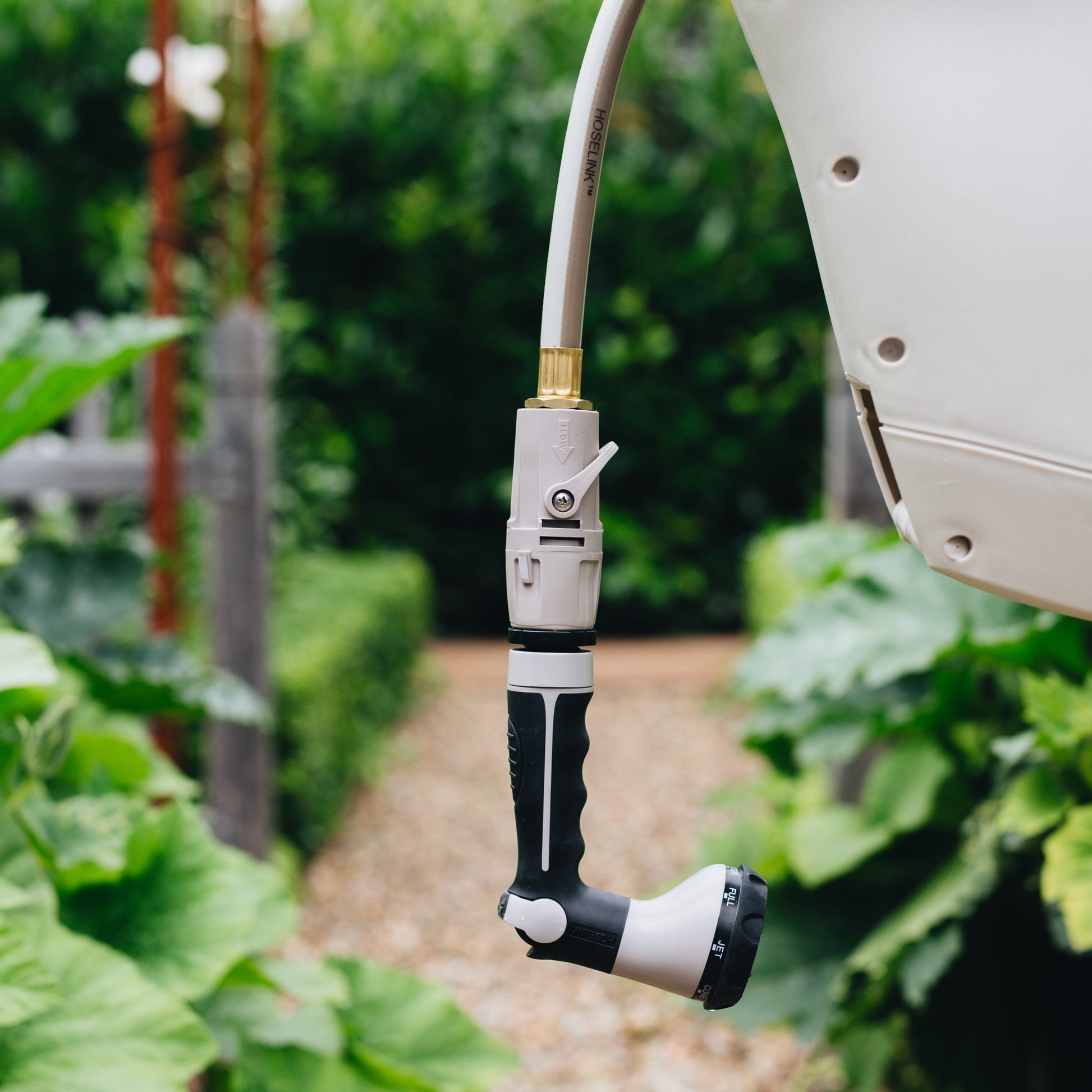 Hose Connector with Flow Control and Accessory Connector with swivel attached to spray gun and hose reel 