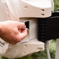 Person attaching velcro tab at rear of beaige Evolve Hose Reel Cover