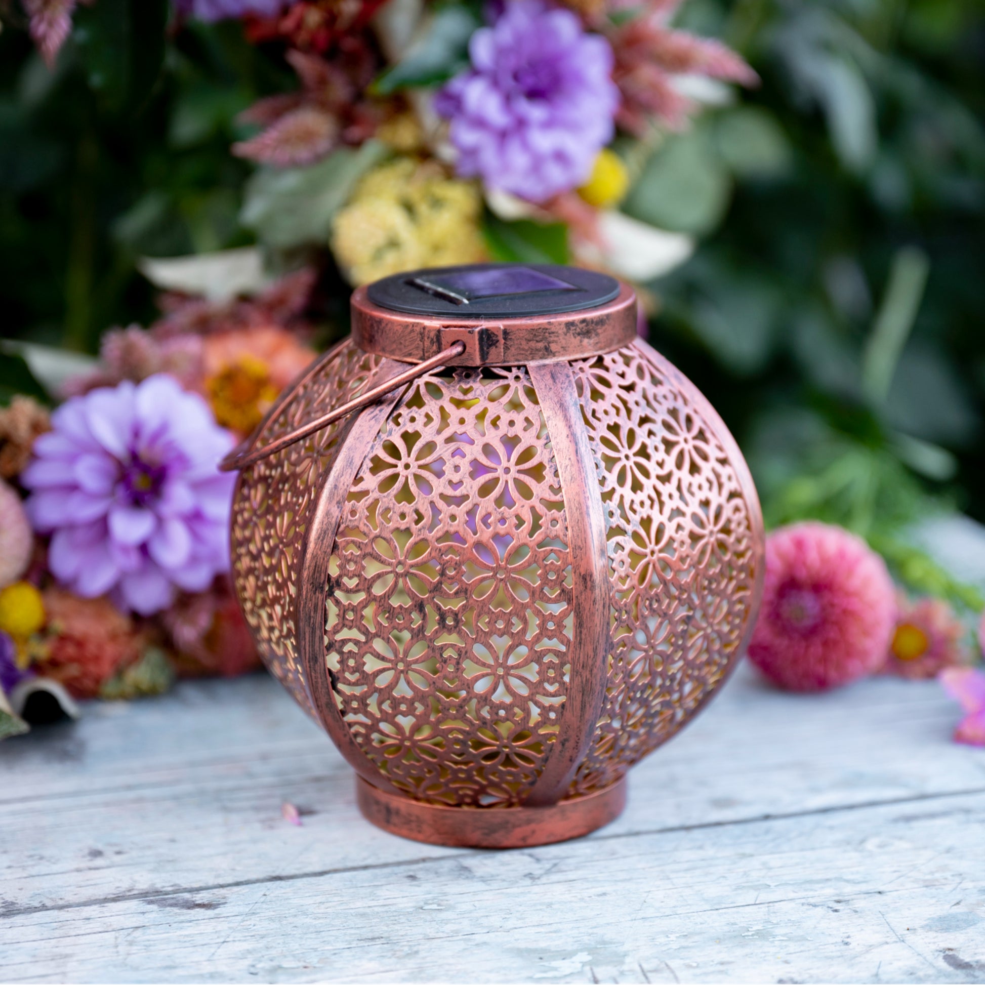 moroccan solar lantern on table with flowers