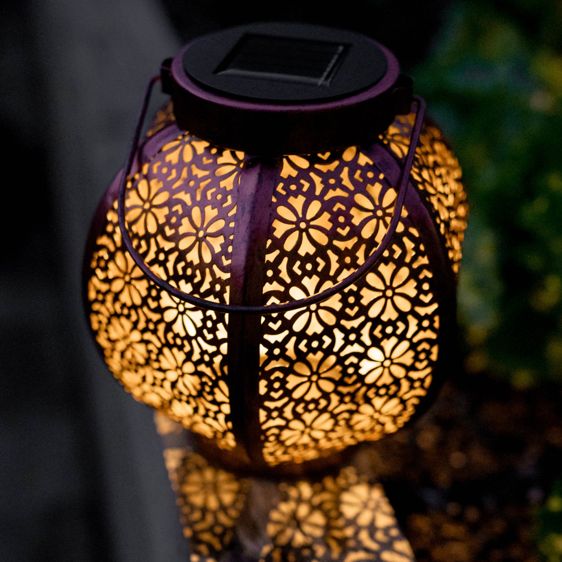 moroccan solar lantern on edge of garden bed