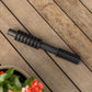 evolve mounting post insert laying on a timber deck with red flowers in the foreground