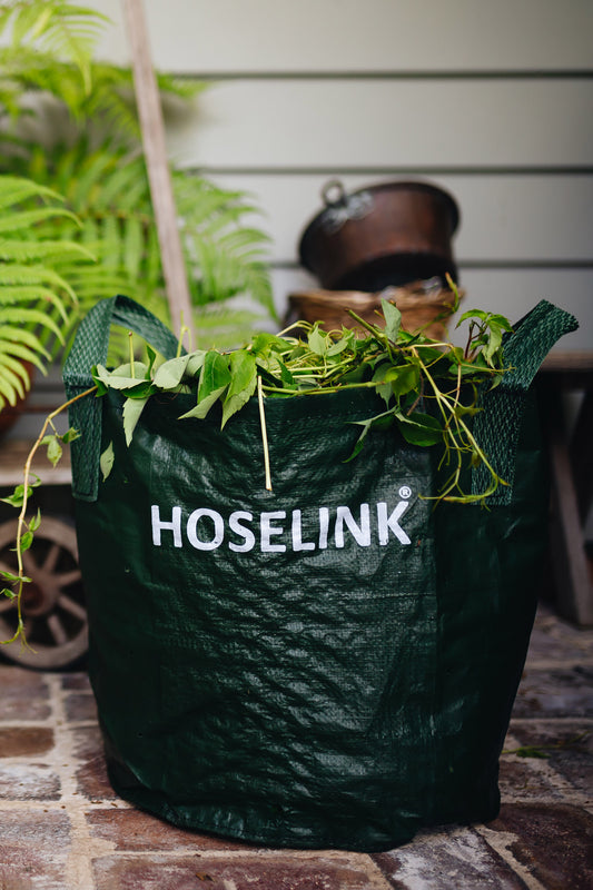 Green Hoselink Planter Bag with white Hoselink logo full of garden waste