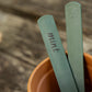 Two recycled plastic sage green plant labels in terracotta pot - one with mint written on