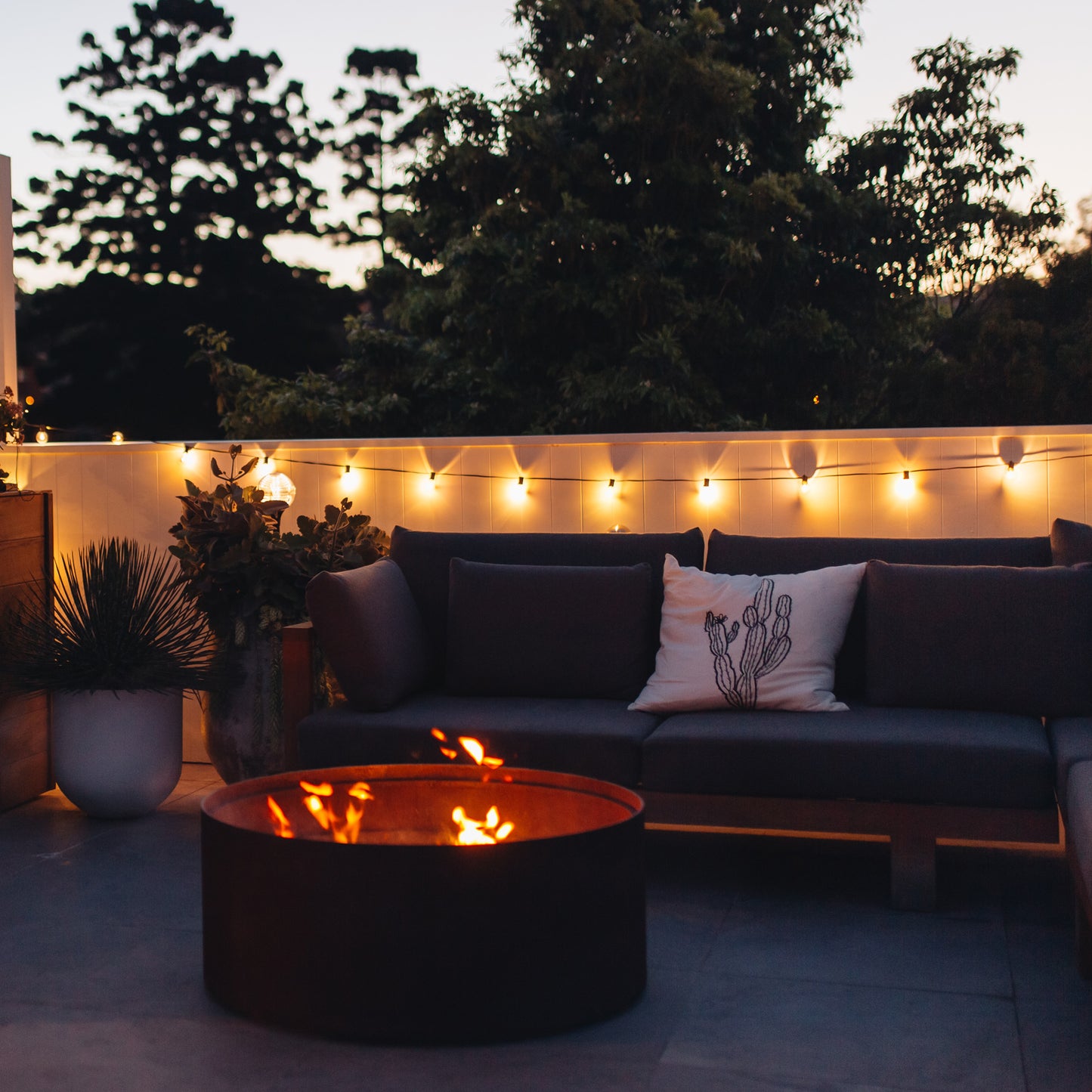 warm white solar party lights hanging on an outdoor wall adding atmosphere to an outdoor sitting area