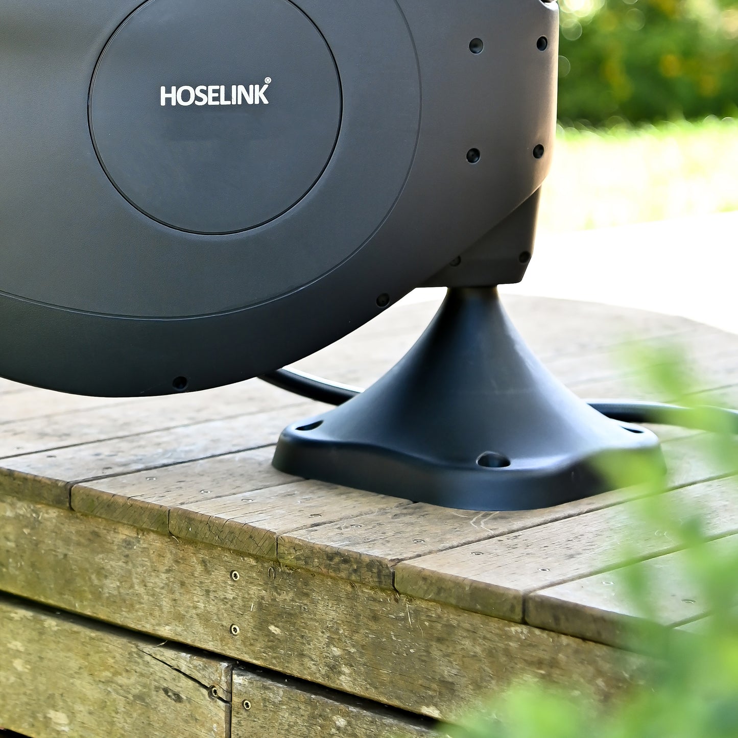 Close up of a black fixed ground mount on a deck.