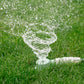 round sprinkler watering the grass in a circle motion
