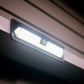 wide angle solar floodlight mounted to top of door and shining brightly