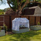 Garden bed with a white mesh cover in a backyard setting
