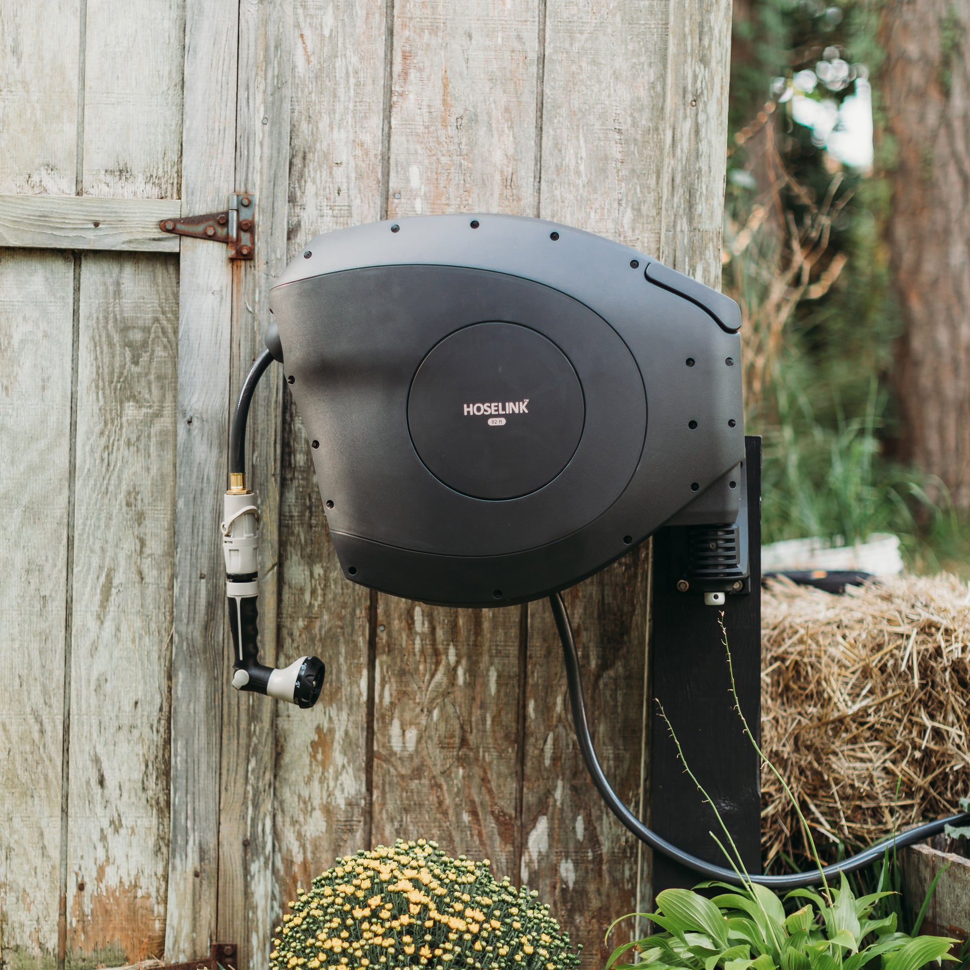 charcoal house reel mounted on a post against a timber wall