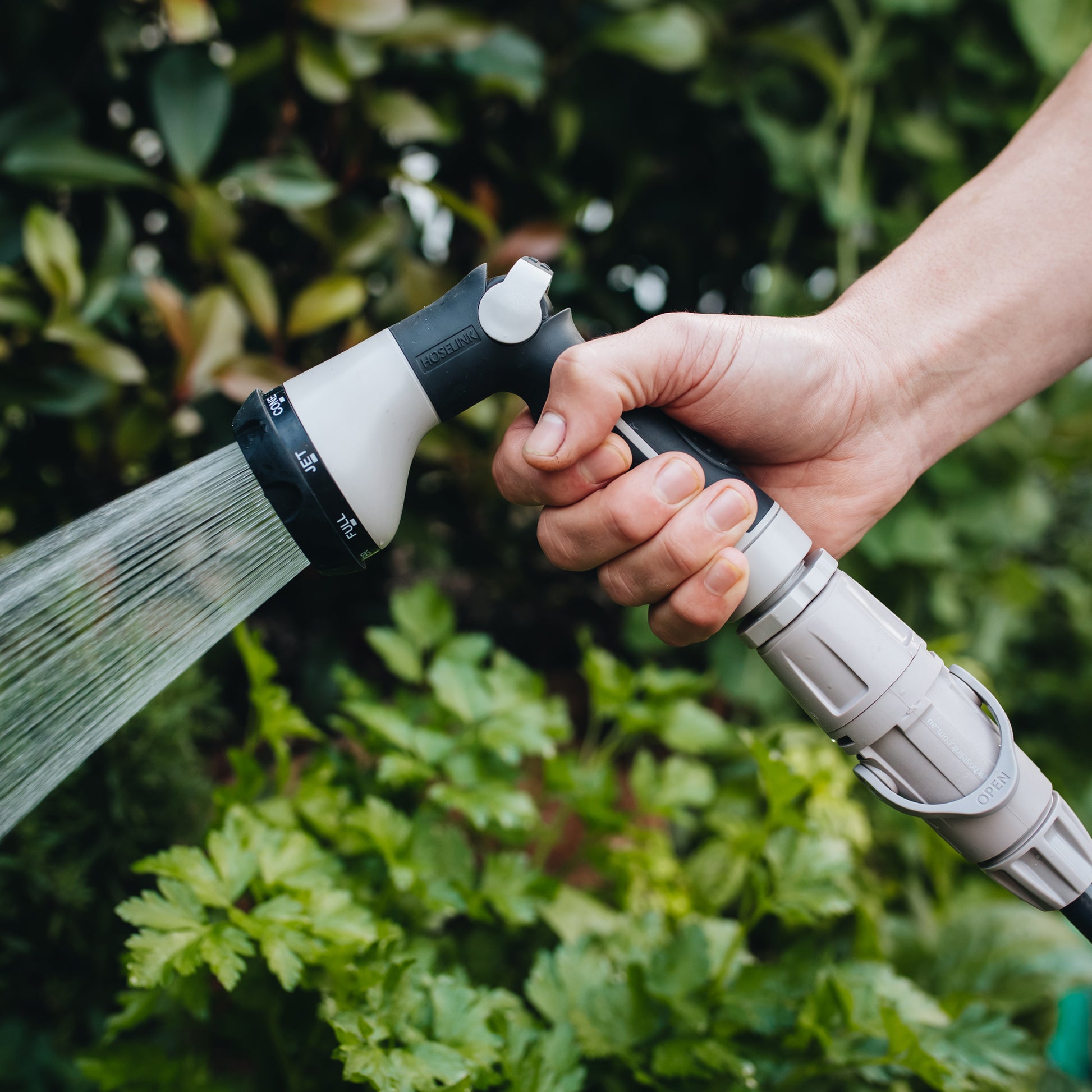 spray gun being held while watering the garden