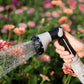 sspray gun being held while watering the garden