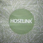 close up of green fern pattern with a hoselink logo in the middle 