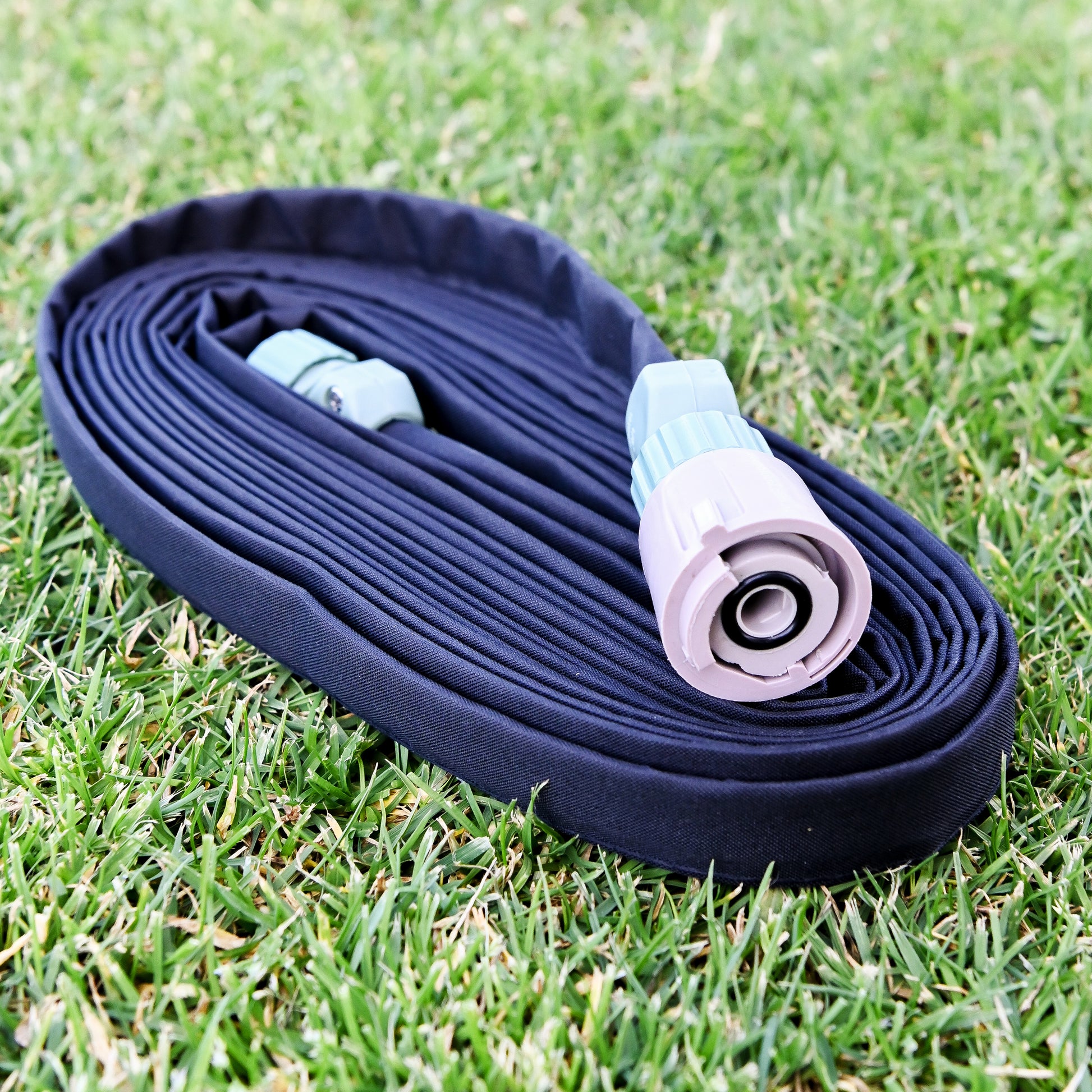 weeper hose with hose connectors attached coiled up on the lawn