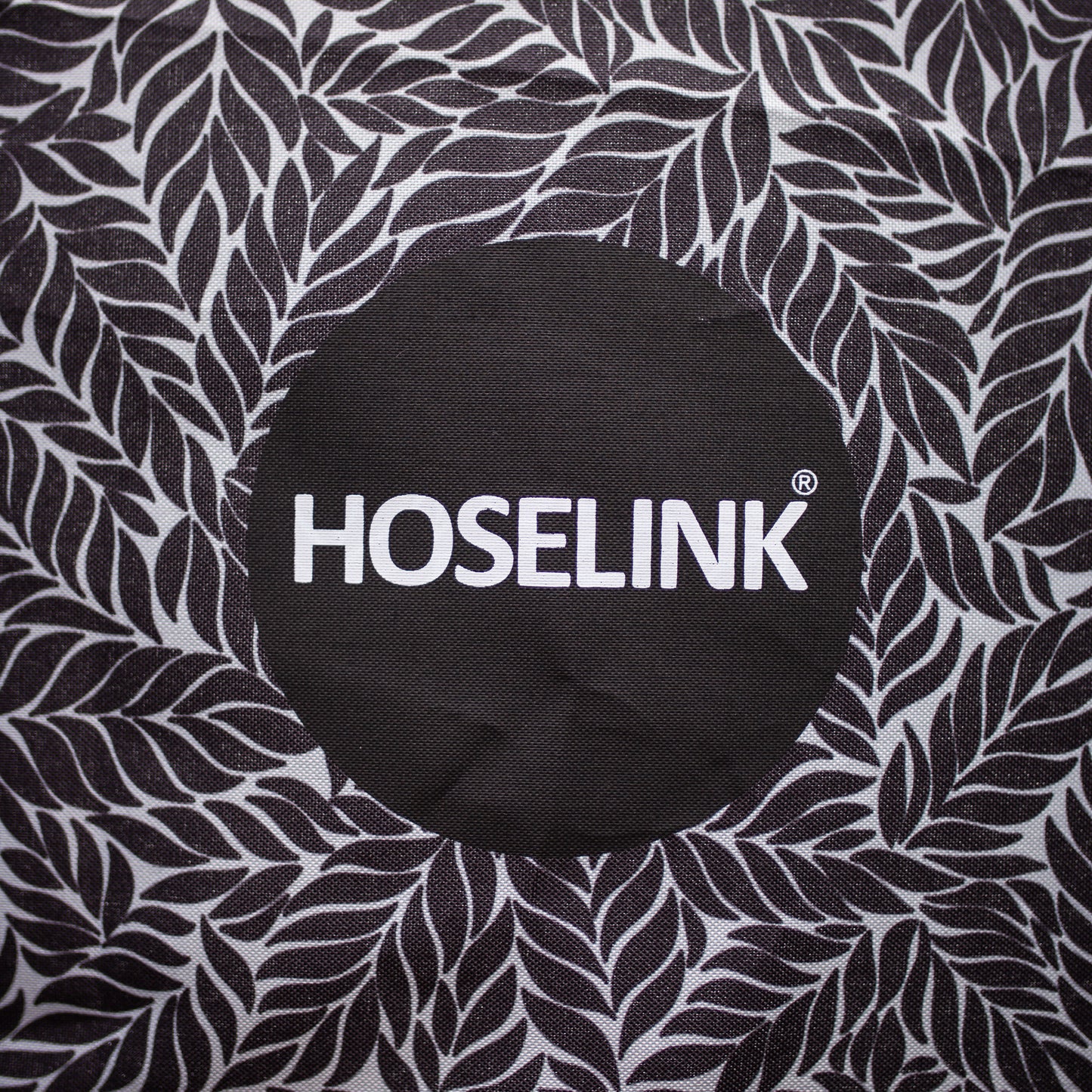 close up of charcoal fern pattern with hoselink logo in the middle